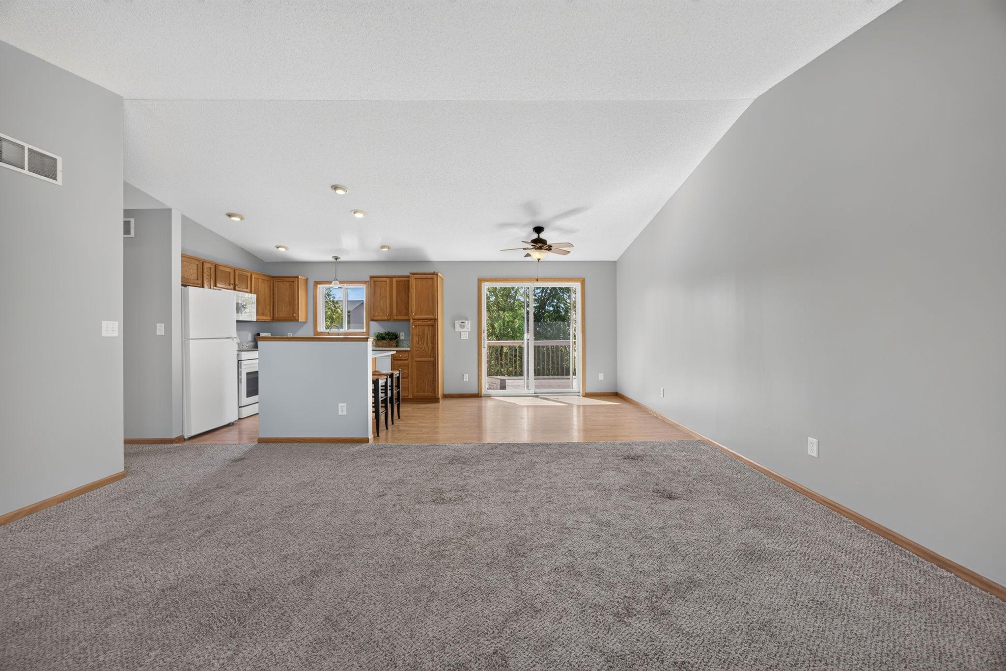 Spacious living room conveniently located just off the kitchen and dining area, creating an easy flow for everyday living and entertaining. The generous layout offers plenty of room for a cozy sectional, TV, and additional seating