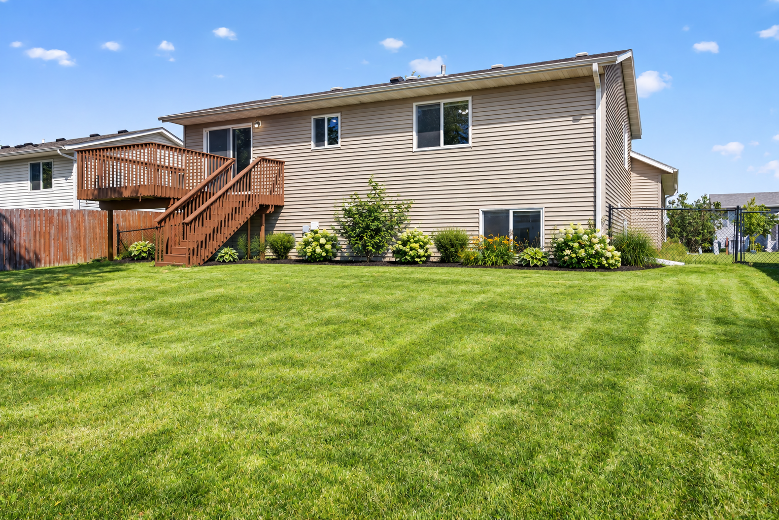 Expansive, fully fenced backyard offering plenty of space for outdoor entertaining, play, pets, gardening, or simply enjoying the outdoors. AI Staged.