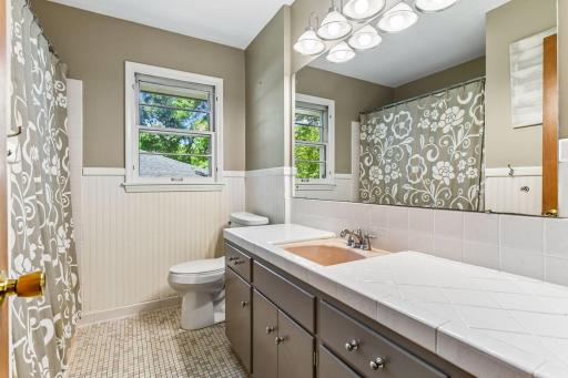 The second bath on this level is brimming with original character and has a shower / tub combo.