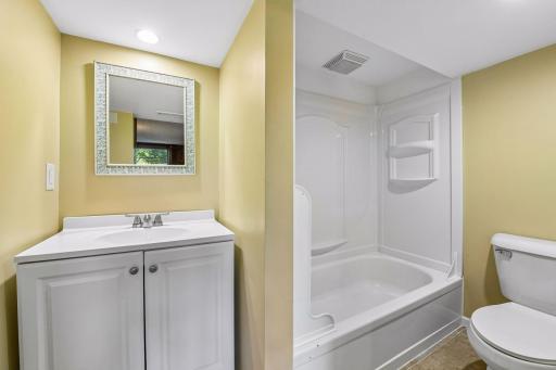 This full bathroom has a shower / tub combo.