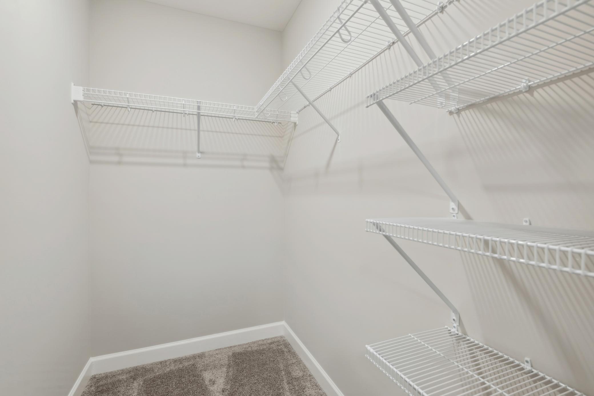 (Photo of a decorated model, actual homes finishes will vary) The primary bedroom features an incredible walk-in closet.