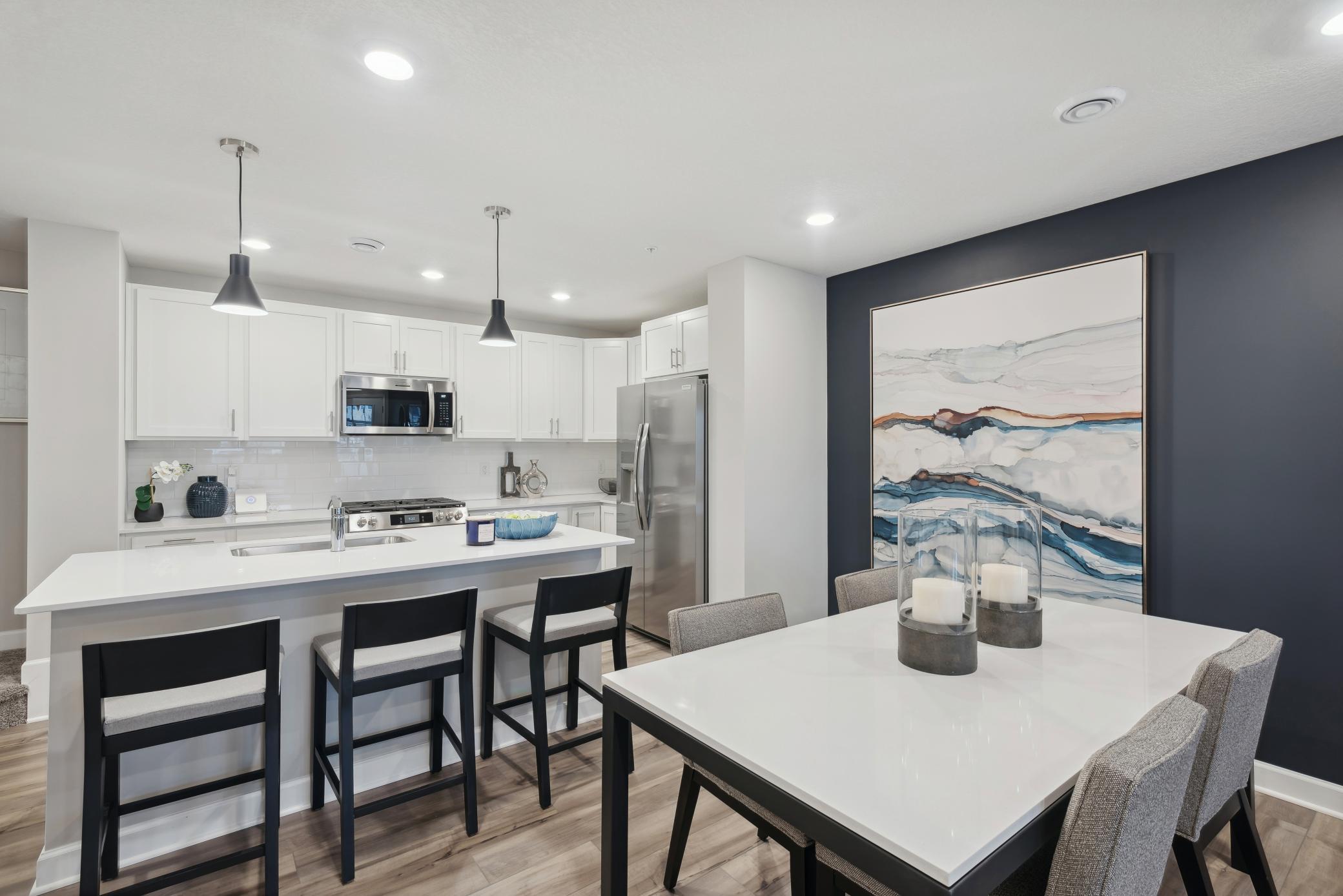 (Photo of a decorated model, actual homes finishes will vary) Enjoy a meal at the dining room table!