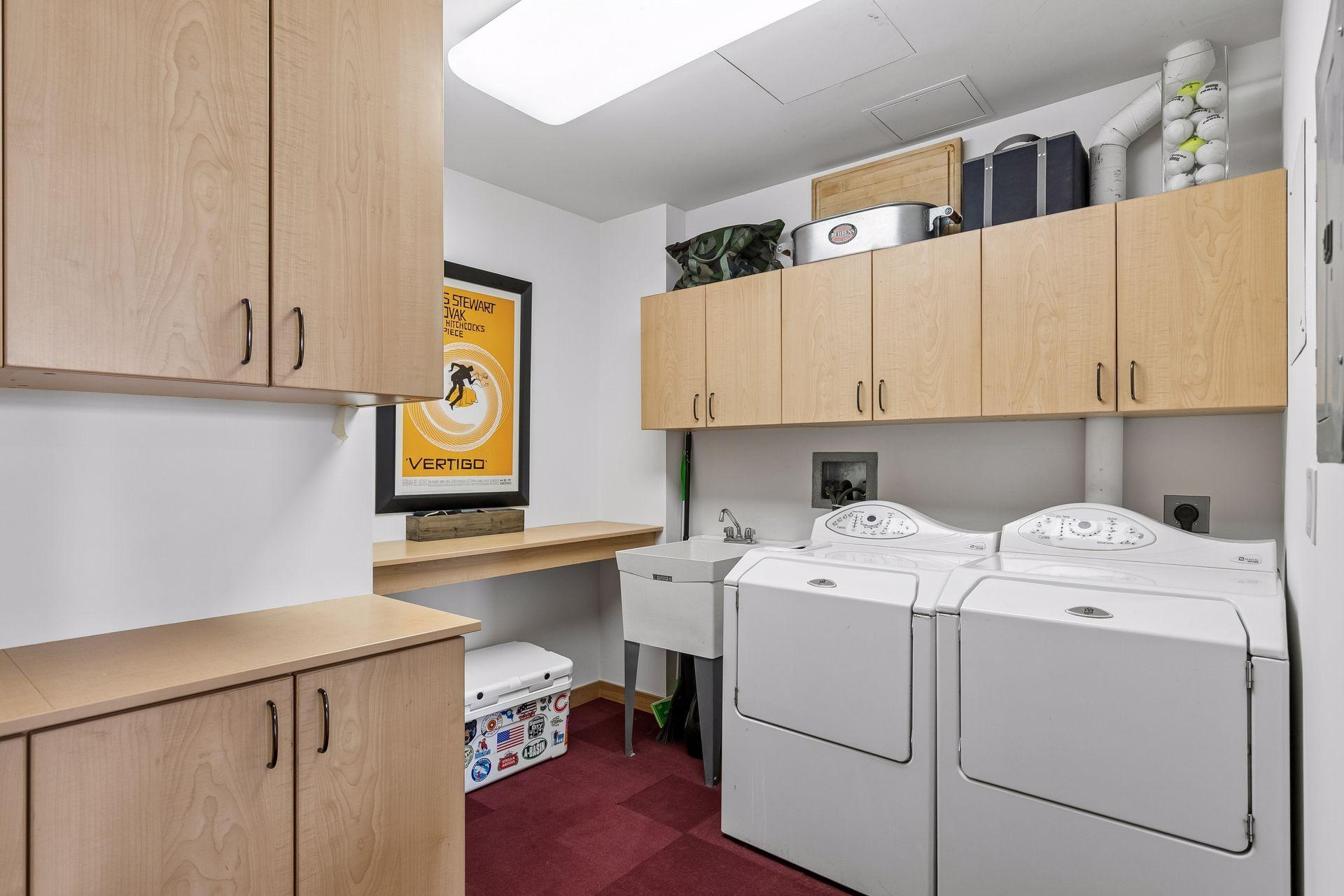 Laundry room with cabinetry and folding counter