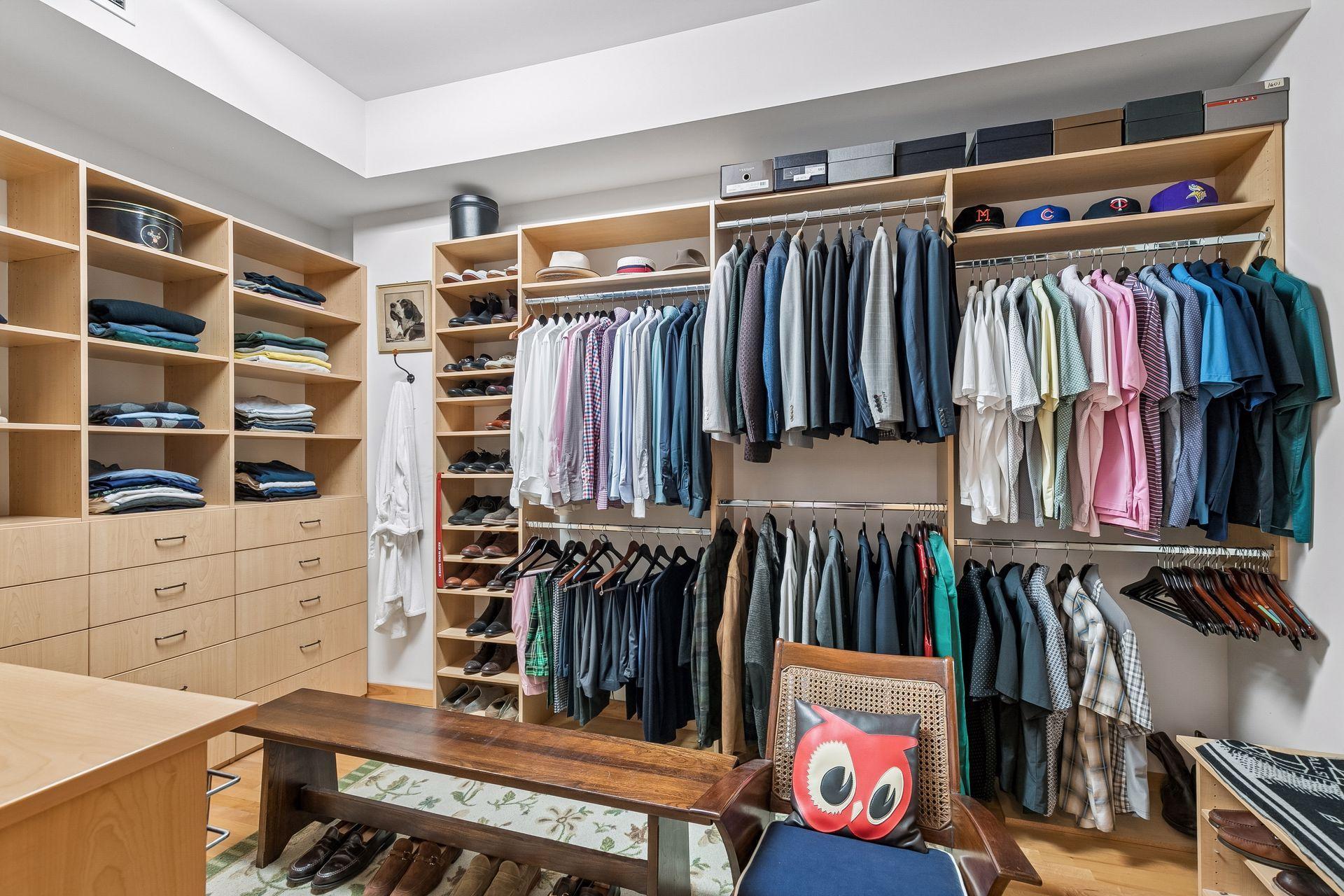 Primary walk-in closet — custom built-ins wall to wall