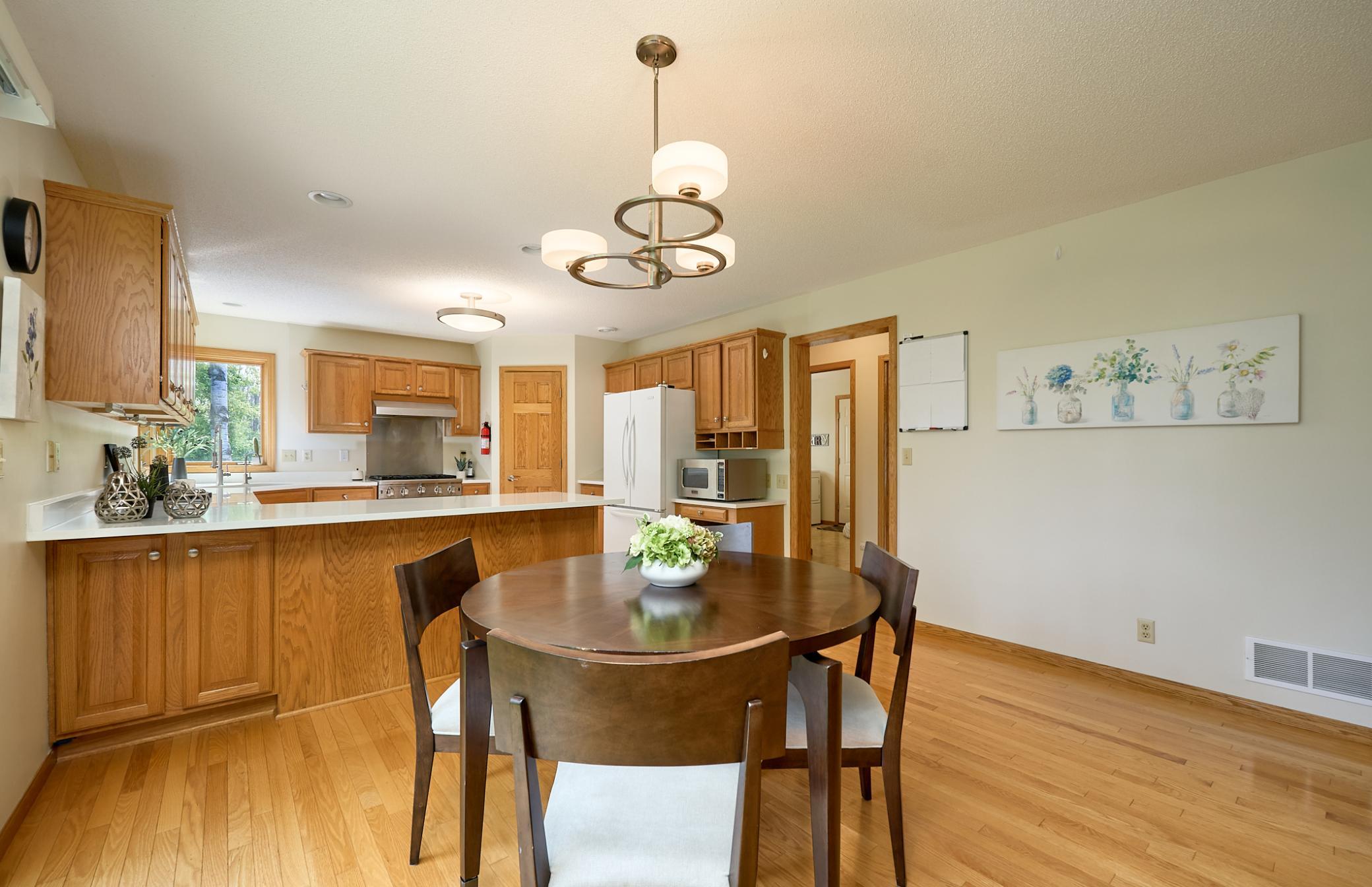 Large granite-top breakfast bar and open floor-plan dining room.
