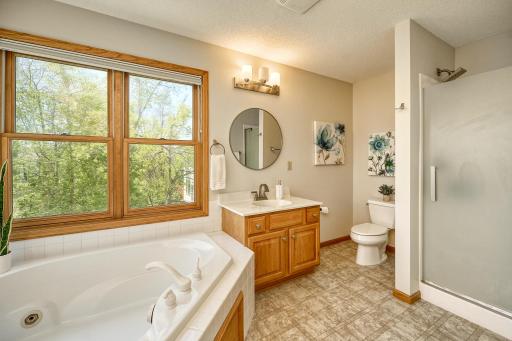 Primary Bedroom Suite with corner tub, two separate vainities, and step-in shower