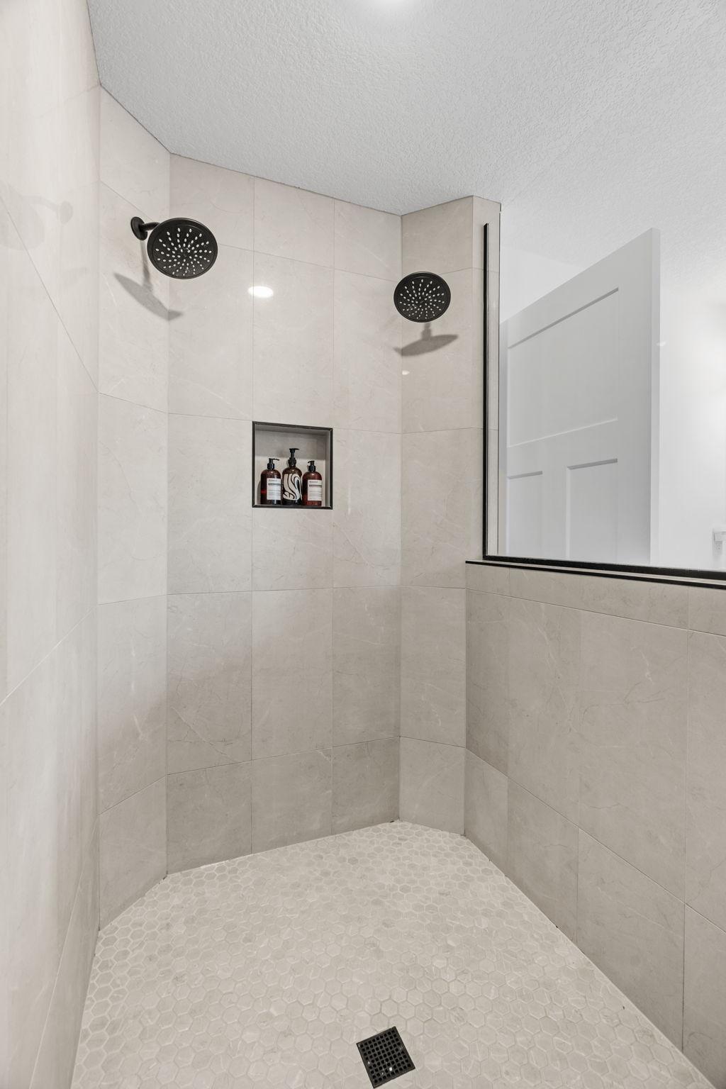Stunning Serenity Shower w/ floor-to-ceiling tile + dual shower heads