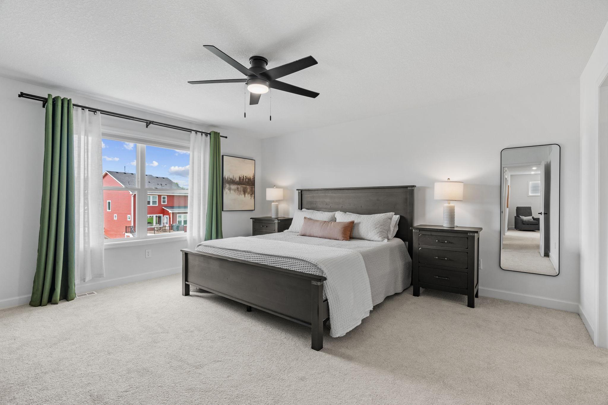Oversized Primary Suite w/ beautiful ensuite featuring dual sinks, quartz counters, upgraded Serenity Shower w/ floor-to-ceiling tile + dual shower heads & walk-in closet.