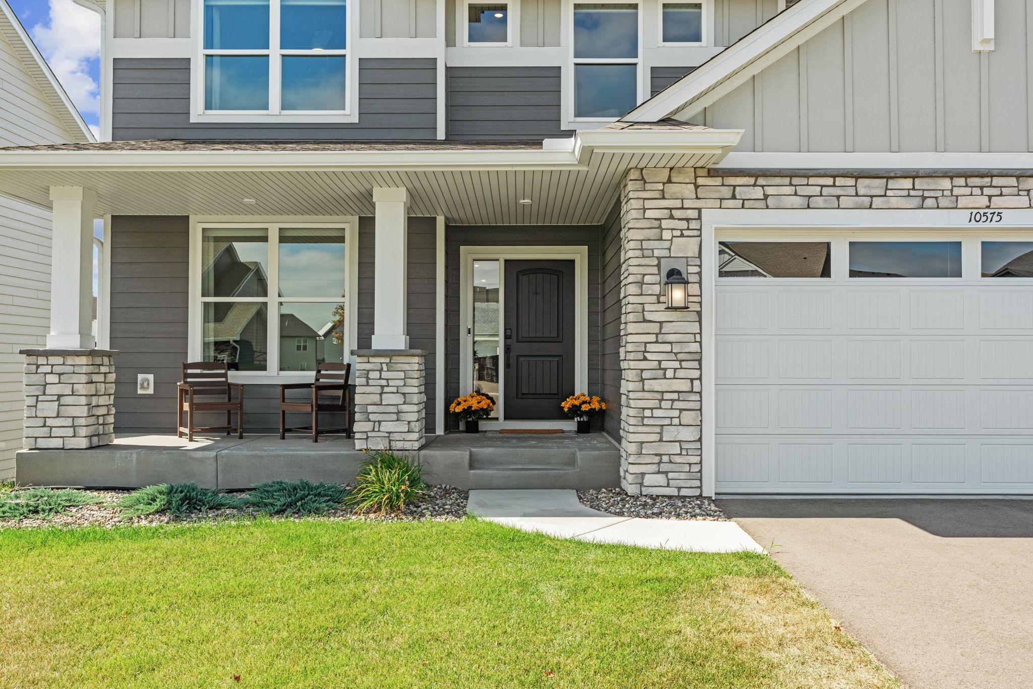 Amazing curb appeal w/ welcoming front porch, stunning stone exterior + Ring doorbell. L