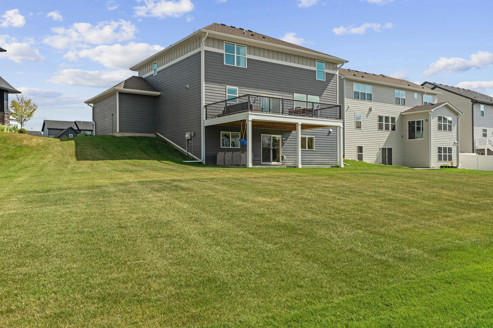 Spacious backyard w/ newly added 17x20 TimberTech maintenance-free deck w/ lighting + drink rail.