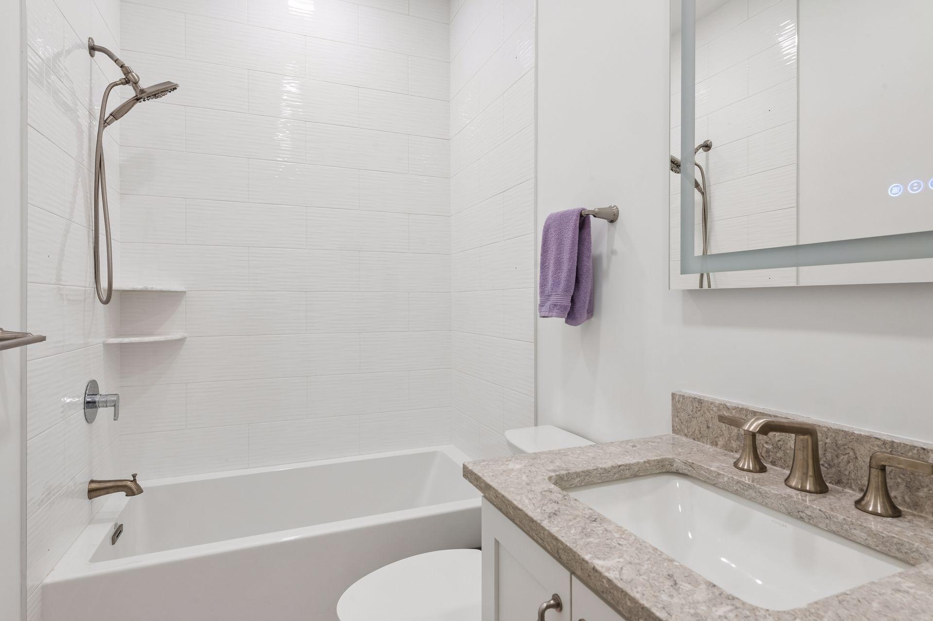 Main level secondary bedroom's private full bath