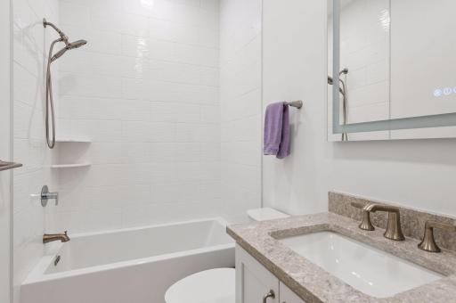 Main level secondary bedroom's private full bath
