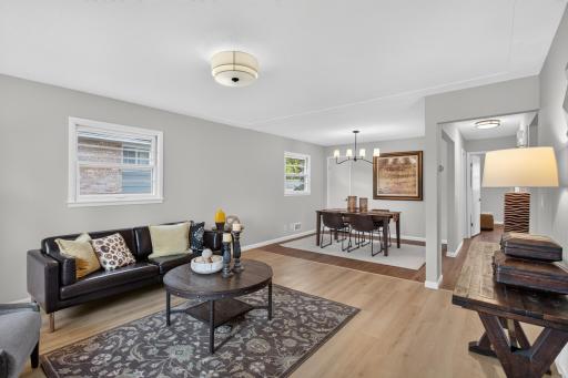 Open living room with new LVP flooring and fresh paint throughout.