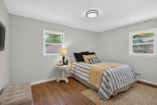 Primary bedroom on the main level with fresh paint and refinished hardwood floors.