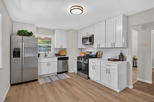 Updated kitchen with new stainless steel appliances, cabinets, countertops, backsplash and LVP flooring.