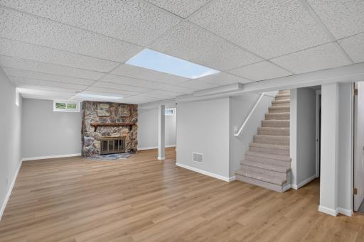 Finished lower level with new LVP flooring and fire place.
