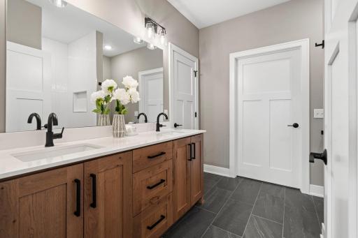 Upscale primary bathroom featuring a spacious double vanity, modern fixtures and stylish finishes.