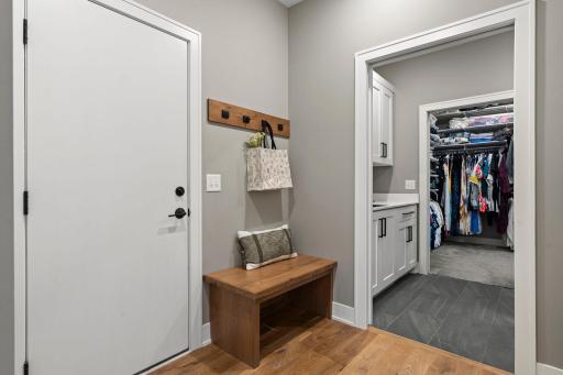 Functional mudroom and drop zone with a large closet allows convenient access to the laundry room and walk in closet.