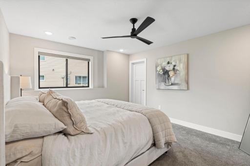 Spacious additional bedroom with neutral finishes, large window and generous walk in closet space.