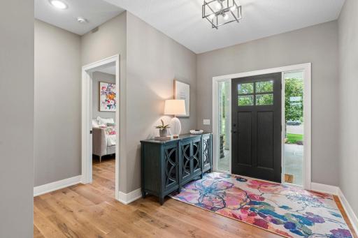 Bright and welcoming foyer with an impressive front door and opens to the covered front porch.