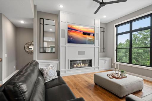 Stunning fireplace with custom surround and built ins creates a beautiful focal point in the main level great room.