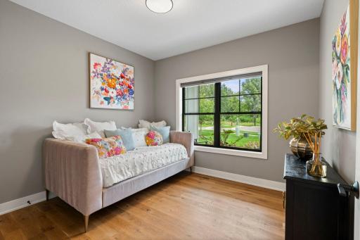 Bright main level bedroom or flex space with a large window and attractive views.