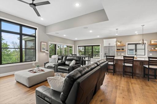 Bright open concept main level featuring expansive windows, abundant natural light and seamless flow between the great room, dining area and kitchen.