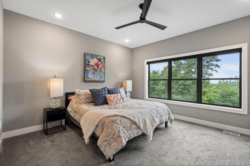 Spacious primary bedroom with large windows, breathtaking views and plenty of natural light.