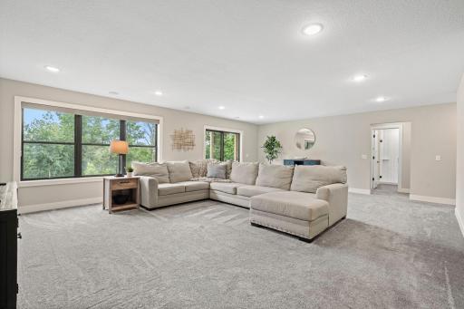 Expansive finished lower level family room offers plenty of space for entertaining, relaxing and gathering.