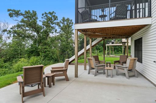 Inviting backyard patio and covered outdoor living area create multiple spaces for dining, entertaining and relaxing.