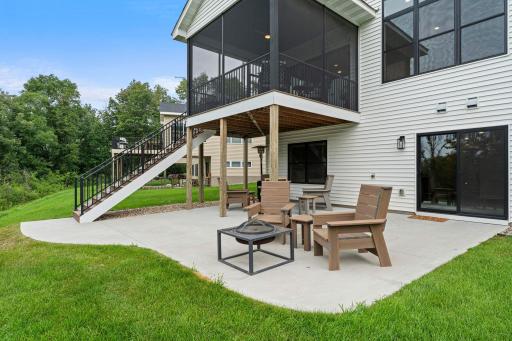 Spacious patio beneath the screened porch provides additional outdoor entertaining space with convenient access to the walkout lower level.
