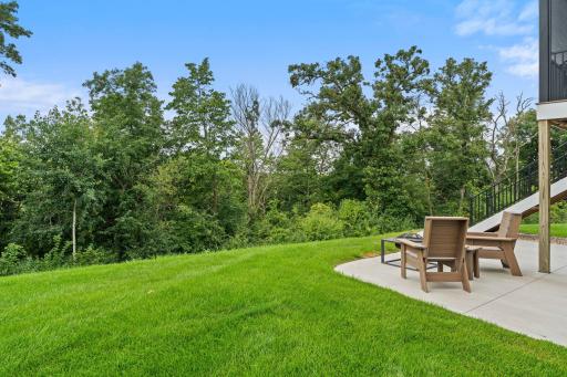 Beautiful backyard setting with mature trees and green space.