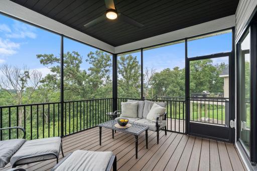 Relax and enjoy the outdoors from the spacious screened porch overlooking the surrounding trees and green space.