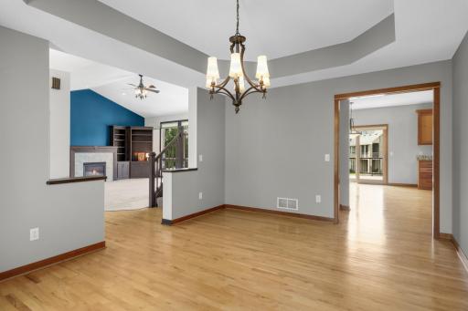 Formal Dinning Room Looking Toward The Kitchen And Living Room. Natural Hardwood Floors Throughout The Main Level, Except The Living Room