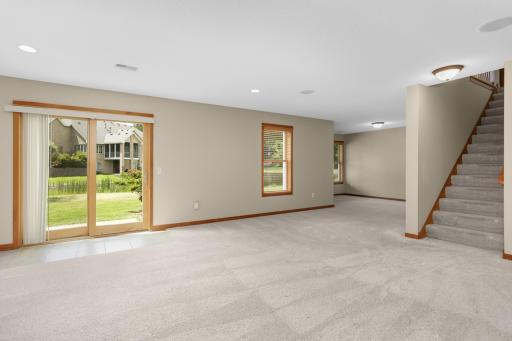 Here Is Another View Showing The Sliding Door Offering Access To The Back Yard. To The Right Of The First Window Is A Good Sized Alcove Area With Two Windows