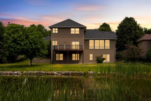 Dusk Photo Of Pond And Back Of This Inviting Home