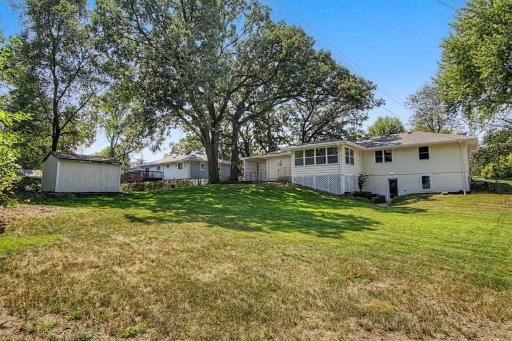 Beautiful spacious fenced yard with mature trees