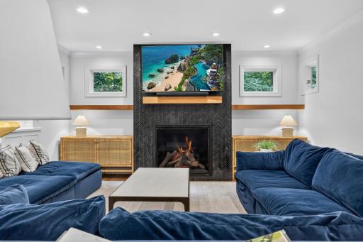 Gas fireplace with marble herringbone tile surround