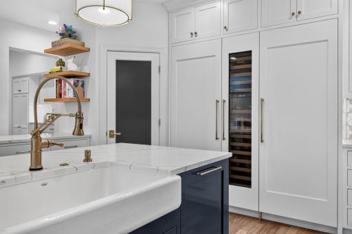 Closet pantry with decorative glass door. High-end appliances include a 60" SubZero cabinet paneled refrigerator with additional wine chiller.