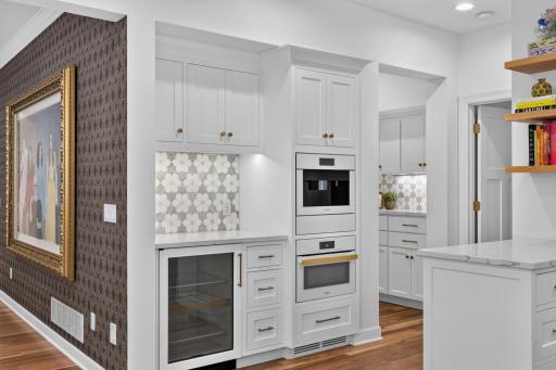 High-end appliances include pair of Miele cabinet paneled dishwashers, Miele built-in coffee maker w/ direct waterline Miele wall oven and SubZero cabinet panel w/ glass beverage refrigerator