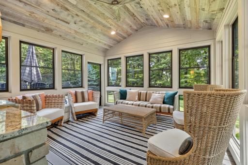 3 Season Porch features wood paneled vaulted ceiling with fan, maintenance free decking and railing, and access to maintenance free deck and paver patio
