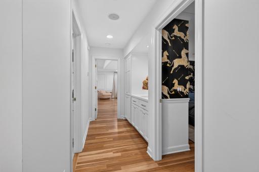 Upper Hall features built-in drop station w/ storage, broom closet, under cabinet lighting and quartz top. Walk-in closet features built-in storage shelving