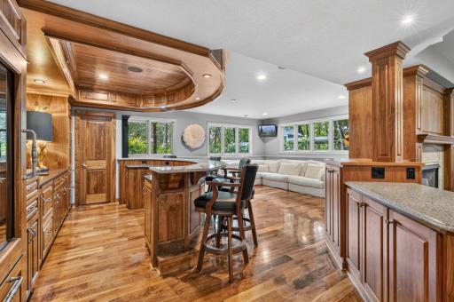 Amusement Area ~ Walnut paneled dropped soffit and bead board ceiling defines the bar area.