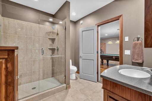 Custom tile shower with frameless glass door and enclosure