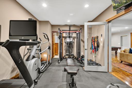 Exercise Room features Full glass French doors with access to the Family Room. Low impact rubber flooring and offers access to the walk-through 3/4 bathroom