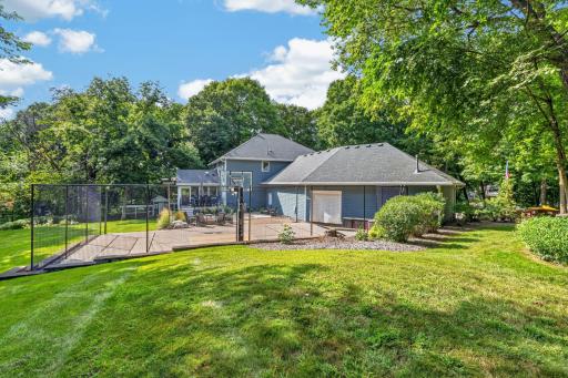 Property features mature shrubs and perennial gardens