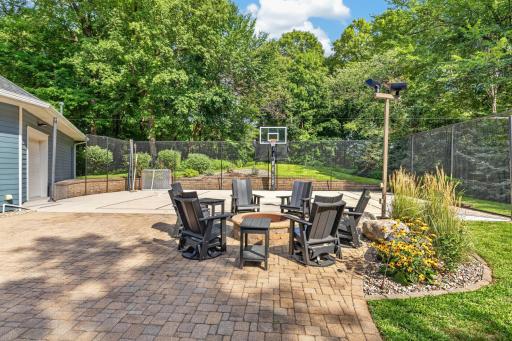 Patio features decorative pavers and built-in fire ring