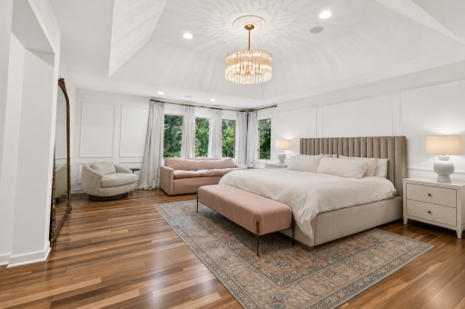Master Bedroom features classic picture frame molding and crown and tray vaulted ceiling with stunning pendant fixture.