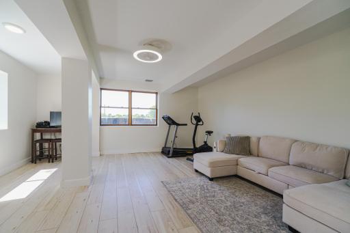 The lower level was raised, and a new, poured concrete foundation was added, including in-floor heat. This space is incredibly bright, and offers additional living space, plus lots of space for guests.
