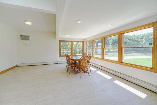 The entry from the front door is lined with windows, and was the former front porch of the 1910 farmhouse! This entire space was renovated to-the-studs, with new ceilings, walls, flooring, trim, windows and more!